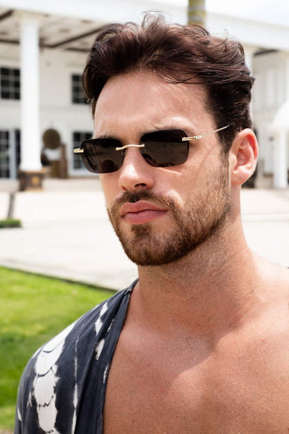 A man wearing Black Rimless Rectangle Sunglasses