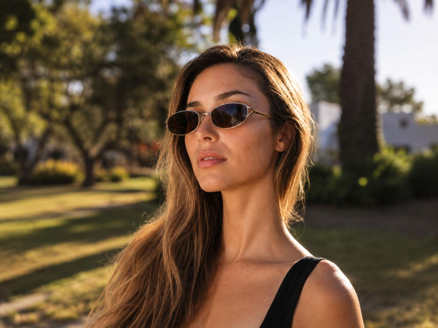 Woman wearing Sleek Metal Frame Vintage Oval Sunglasses
