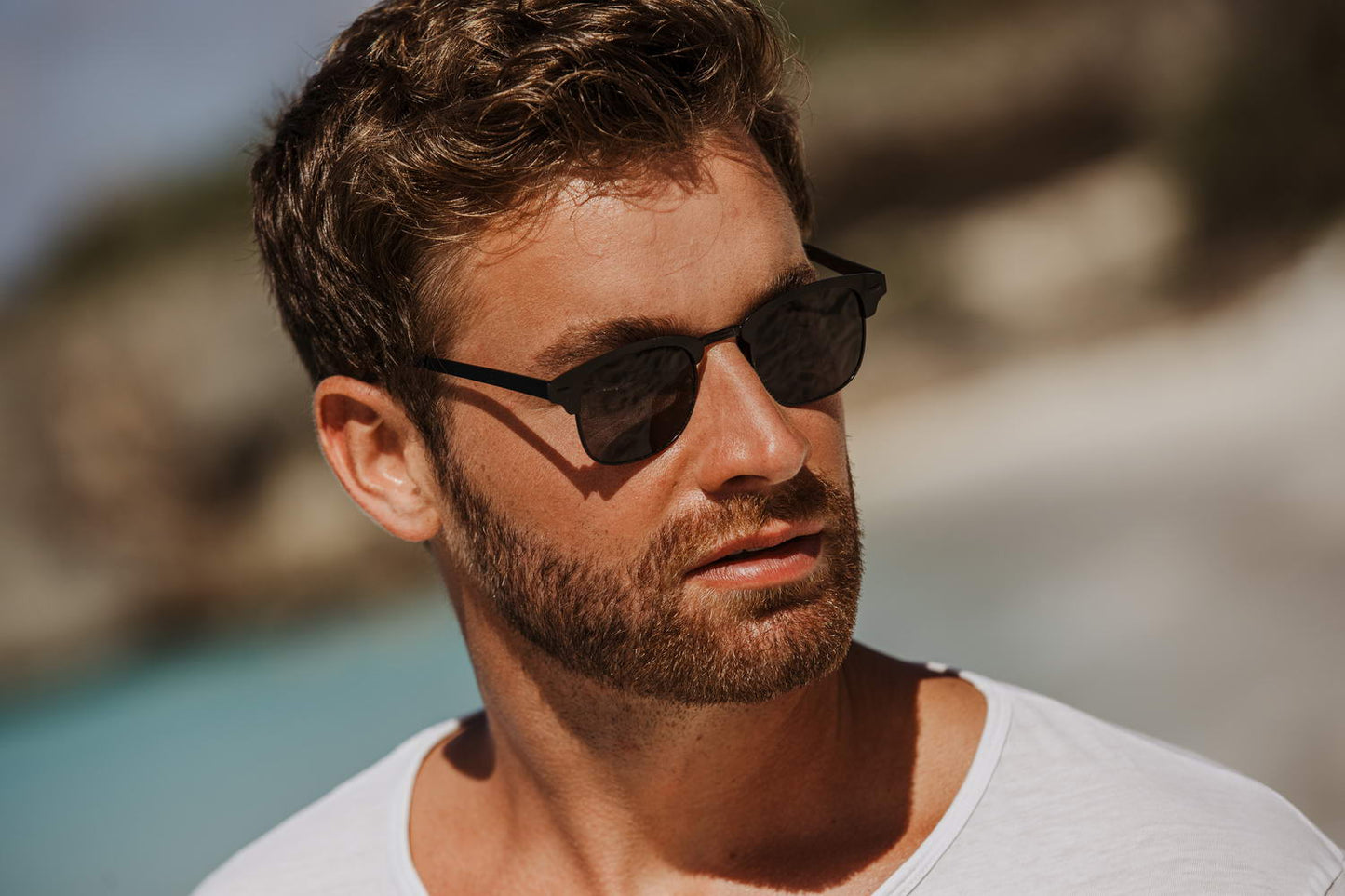 man wearing black clubmasters at paris coastal beach