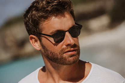 man wearing black clubmasters at paris coastal beach