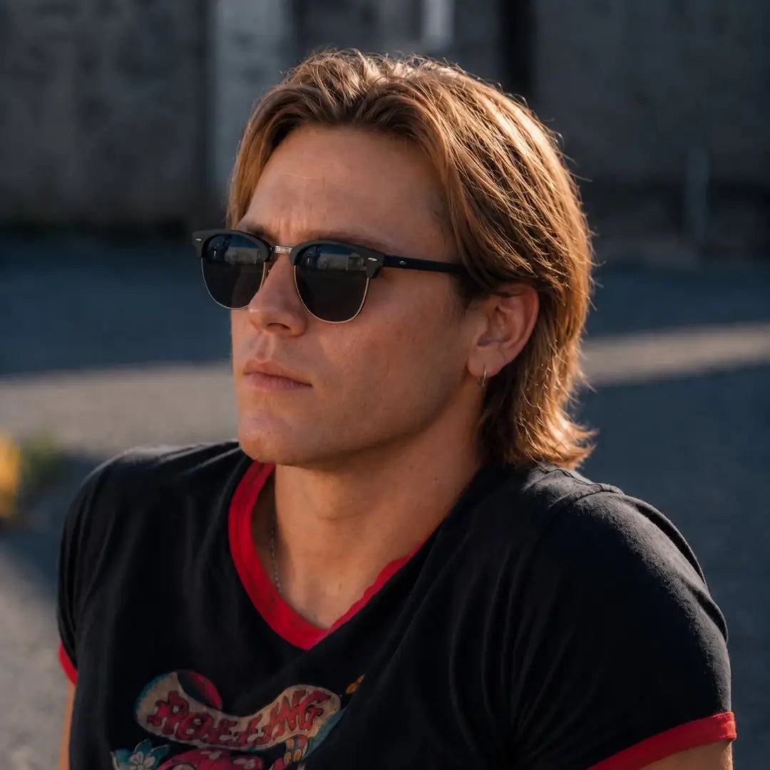 a man wearing black clubmaster sunglasses in london city