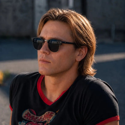 a man wearing black clubmaster sunglasses in london city