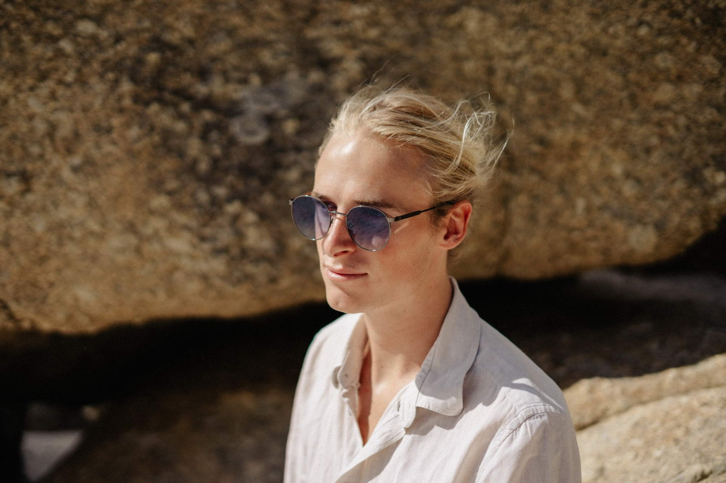 man wearing blue round party sunglasses outdoors — effortlessly cool retro styling that transcends age, the blue tinted lens that belongs on a Parisian terrace as much as a Berlin rooftop. free shipping across UK & Europe.