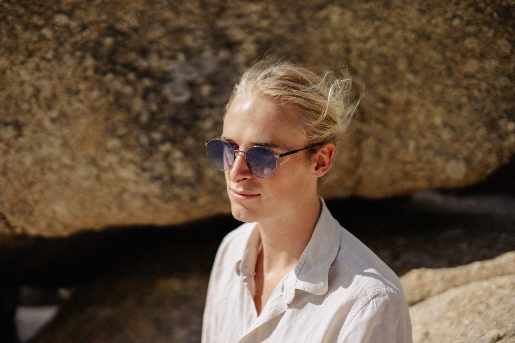 man wearing blue round party sunglasses outdoors — effortlessly cool retro styling that transcends age, the blue tinted lens that belongs on a Parisian terrace as much as a Berlin rooftop. free shipping across UK & Europe.