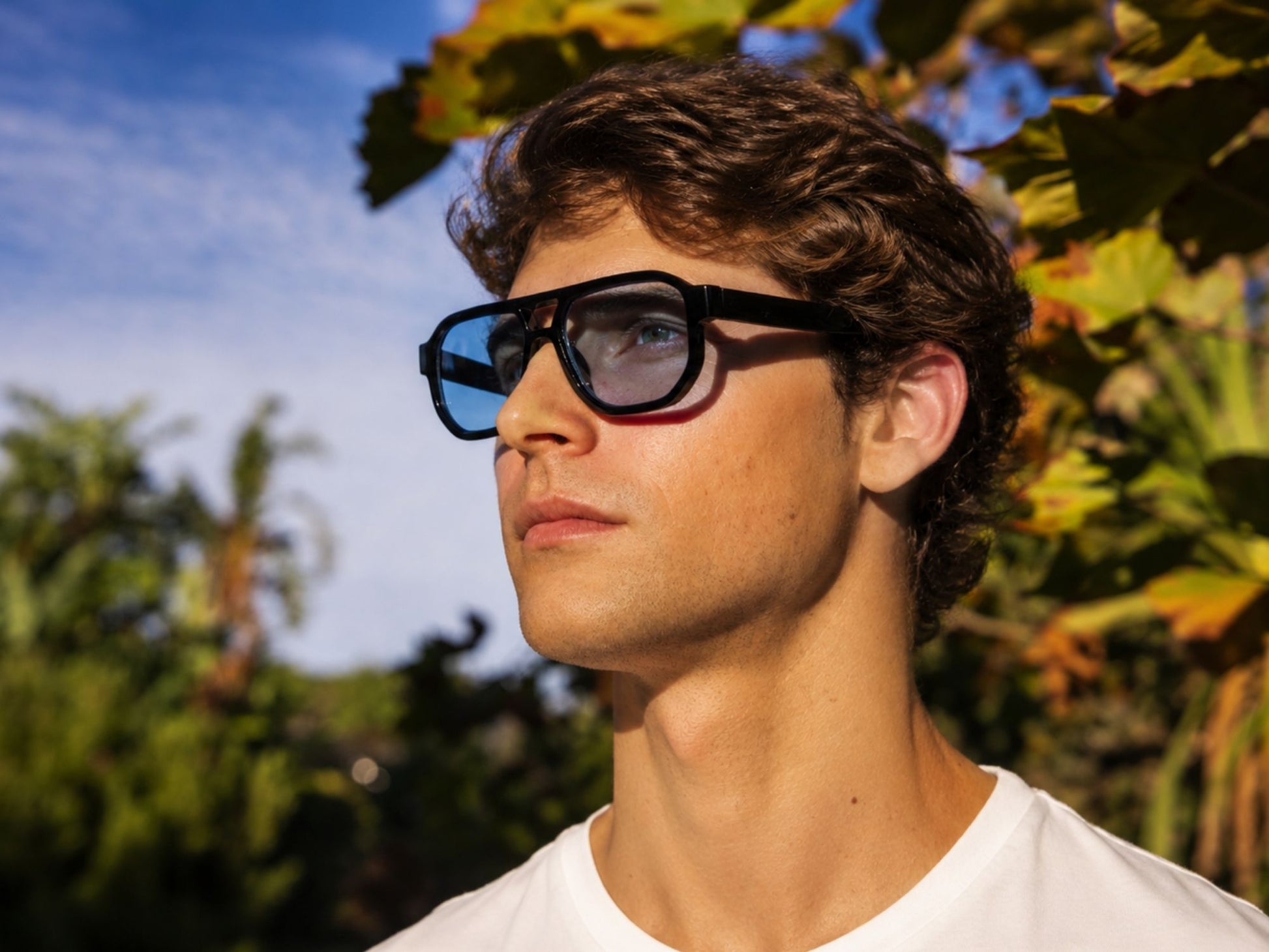 man wearing blue tinted lens aviator sunglasses in london