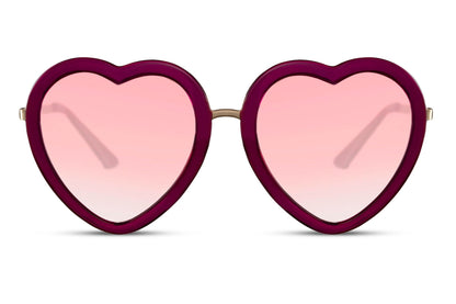 Heart-shaped oversized party sunglasses with a red frame and pink heart-shaped lenses.