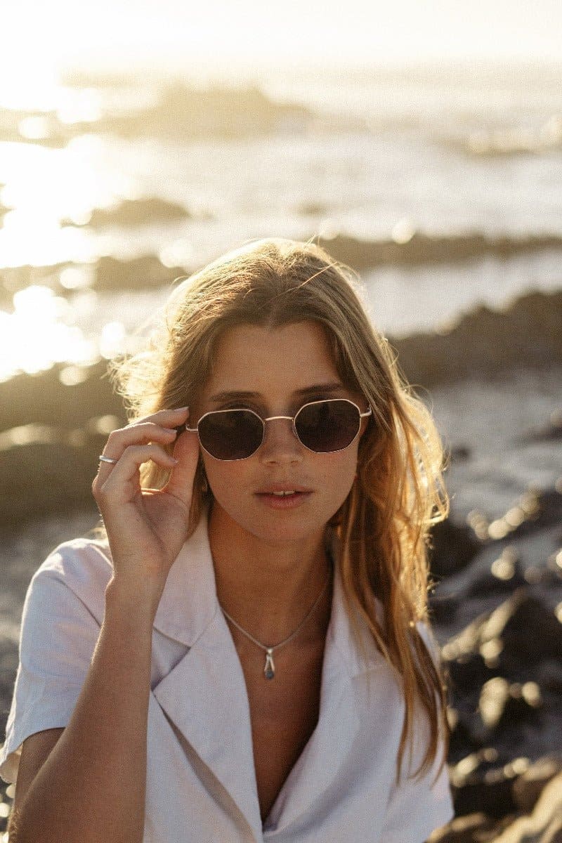 woman wearing brown sunglasses at berlin lake shore