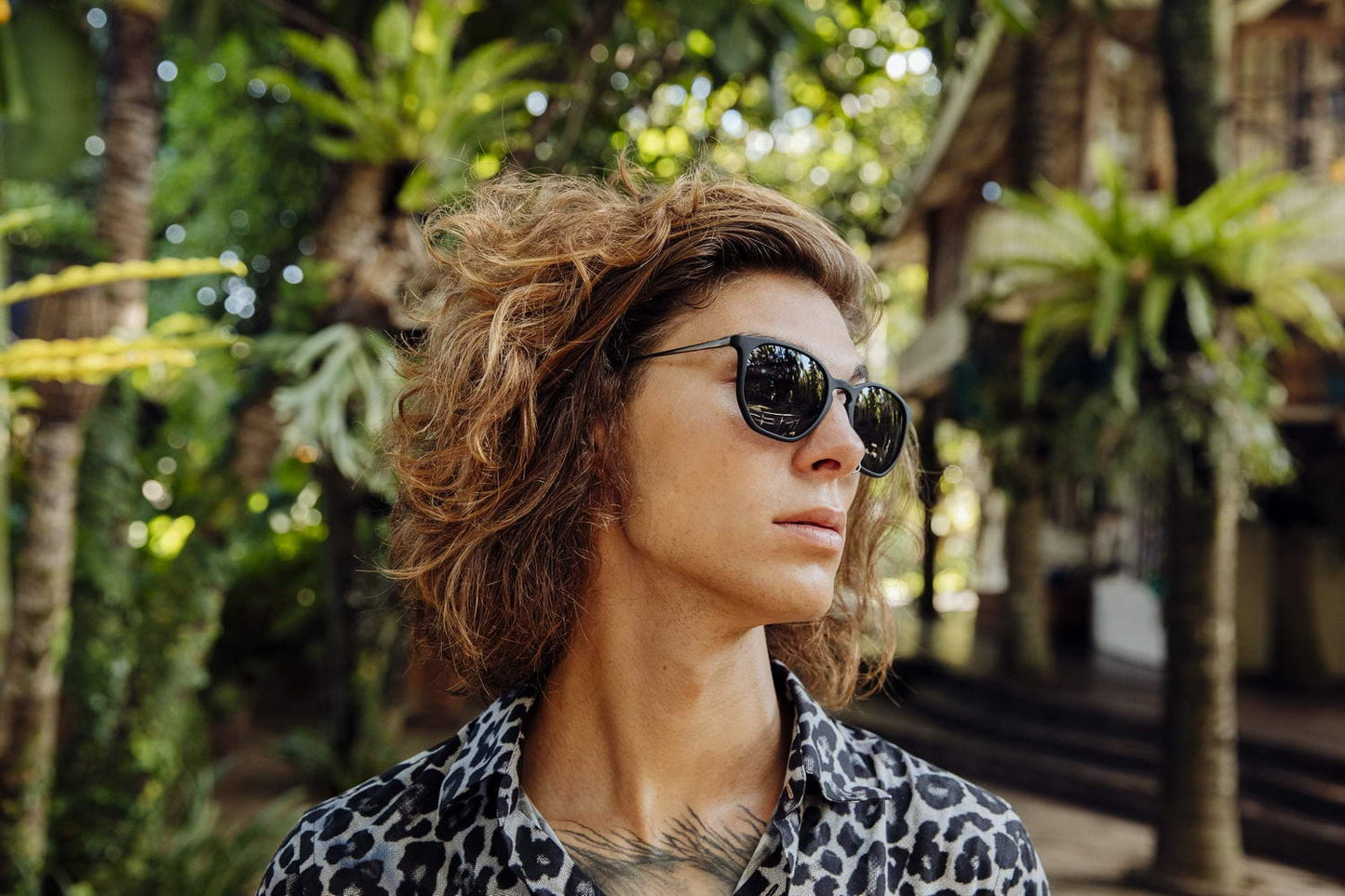 Wearing chic round sunglasses men dark frame polycarbonate black smoke lens UV400 protection bold glamorous chic sophisticated summer city outdoor beach holiday style free UK Europe delivery Sunglass Station