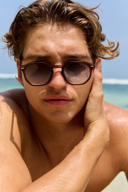 Men wearing Greece geometric round sunglasses tortoiseshell frame teal gradient recycled lens UV400 protection sustainable Mediterranean inspired summer beach holiday outdoor eyewear free UK Europe shipping Sunglass Station