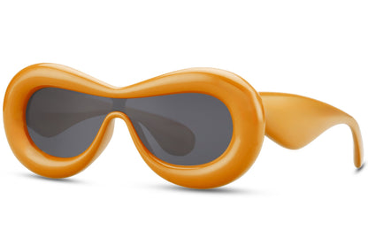 orange puffy oval Ibiza party shades — inflated bubble frame in sustainable recycled polyester, the warm chromatic statement that belongs on a Balearic pool deck as much as a Glastonbury hill | Sunglass Station

