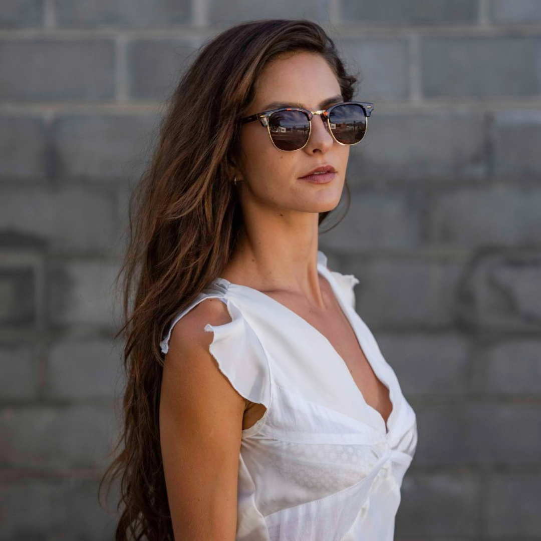 a women in white top wearing leopard print clubmaster sunglasses in UK