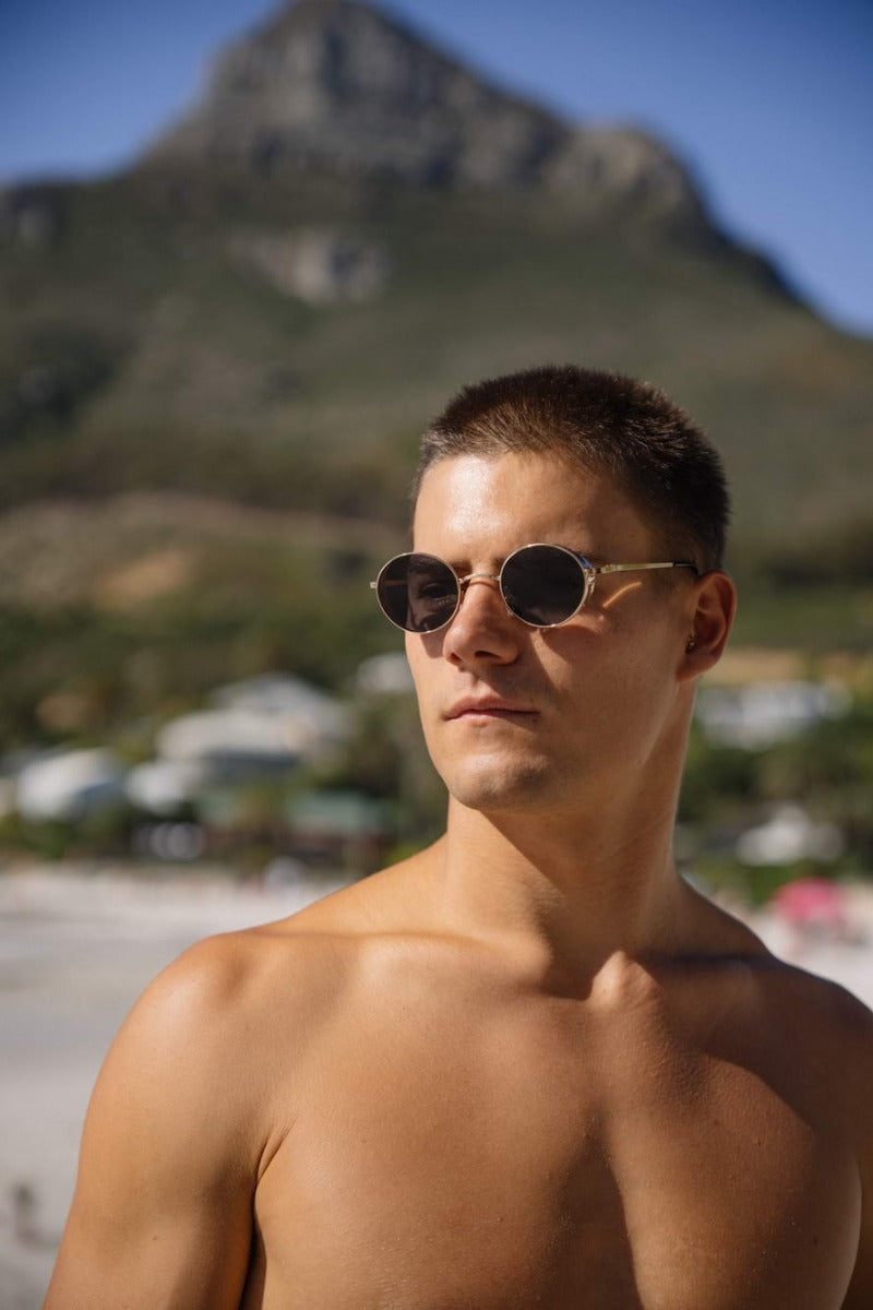 Men wearing London black round sunglasses matte black metal frame jet black lens UV400 protection bold refined trendsetter summer city outdoor beach holiday eyewear free UK Europe shipping Sunglass Station