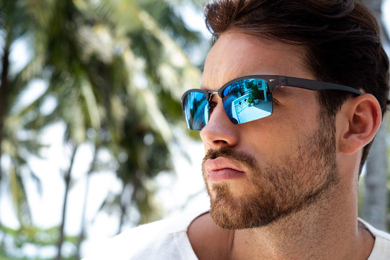 man wearing clubmaster shades in sardinia, italy tropical