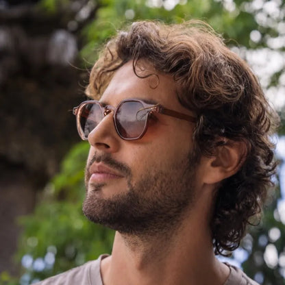 a man wearing narrow & small round sunglasses in London