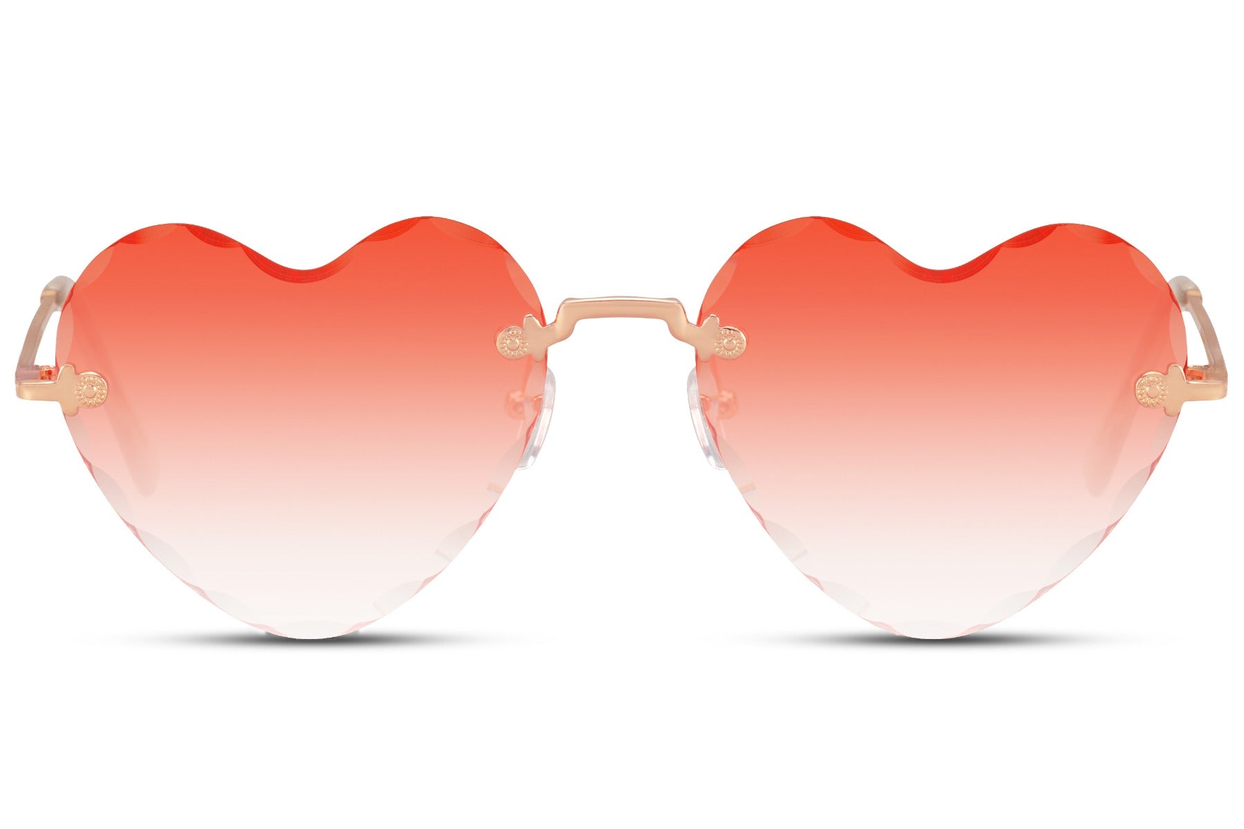 Heart-shaped sunglasses with a golden frame and a red rimless design, featuring a heart-shaped lens.