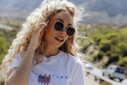 Women wearing Rome gold black round sunglasses gold metal frame deep black lens UV400 protection glamorous elegant Italian inspired summer city outdoor beach holiday eyewear free UK Europe shipping Sunglass Station