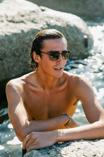 Man wearing retro rectangle aviator sunglasses by Sunglass Station, metal frame eyewear designed for summer and outdoor use