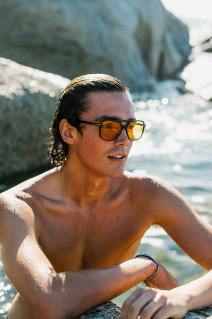 Aviator tinted sunglasses worn on a beach holiday, perfect for relaxed travel styling and sunny day outfits