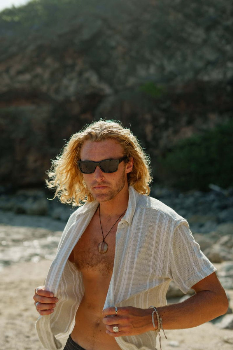 man wearing black rectangle sunglasses by Sunglass Station, stylish unisex eyewear designed for everyday outdoor use with a comfortable fit