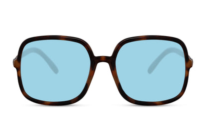 Blue lens oversized sunglasses with modern black frame, fashionable women sunglasses for travel, city outfits and sunny day wear