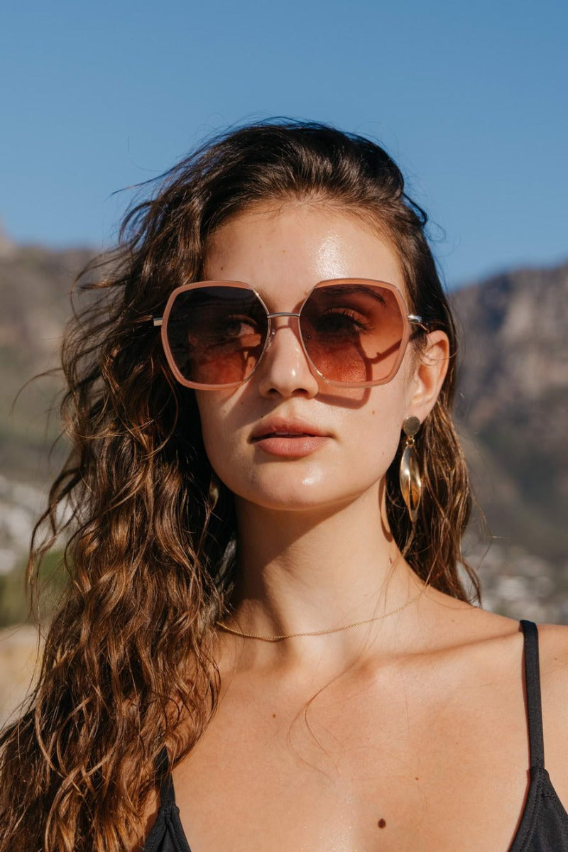 Woman wearing brown oversized sunglasses, fashionable eyewear for summer outfits, holidays and relaxed everyday style