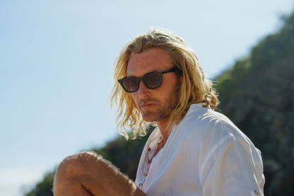 man wearing cat eye sunglasses outdoors with tinted lenses showcasing everyday fashion style