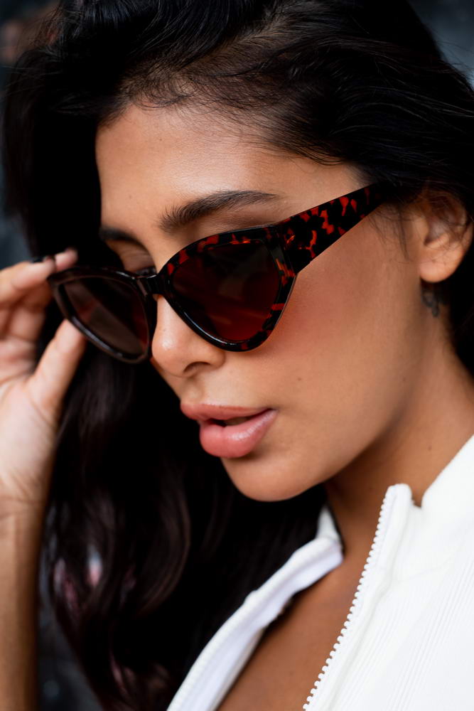 Woman wearing leopard print cat eye sunglasses with a bold and stylish fashion look