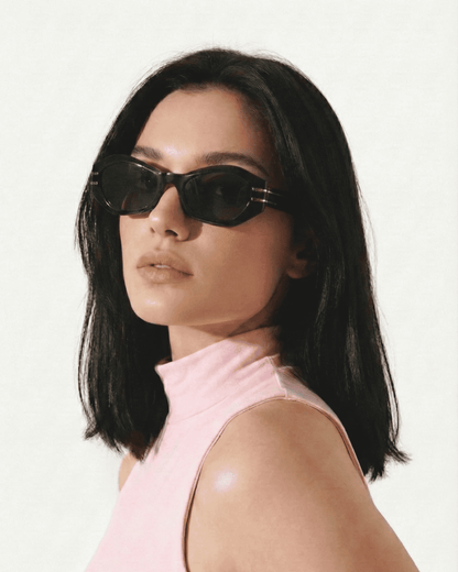 Woman wearing geometric cat eye sunglasses with tinted lenses in a modern everyday style