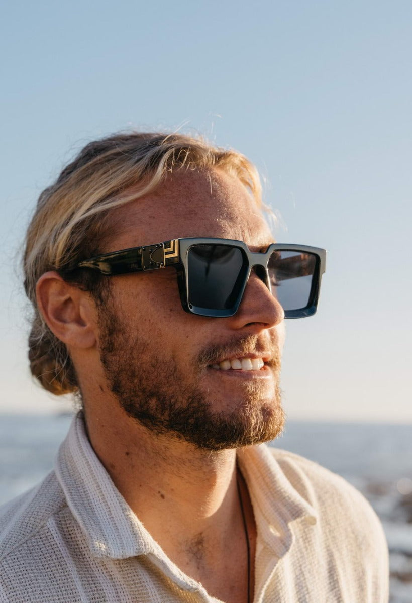 Person wearing oversized square sunglasses in European style, stylish eyewear for travel outfits, city fashion and sunny days