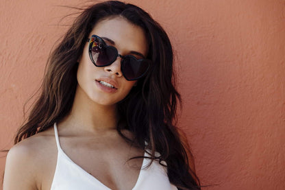 Woman wearing heart shaped sunglasses with stylish outfit and modern look