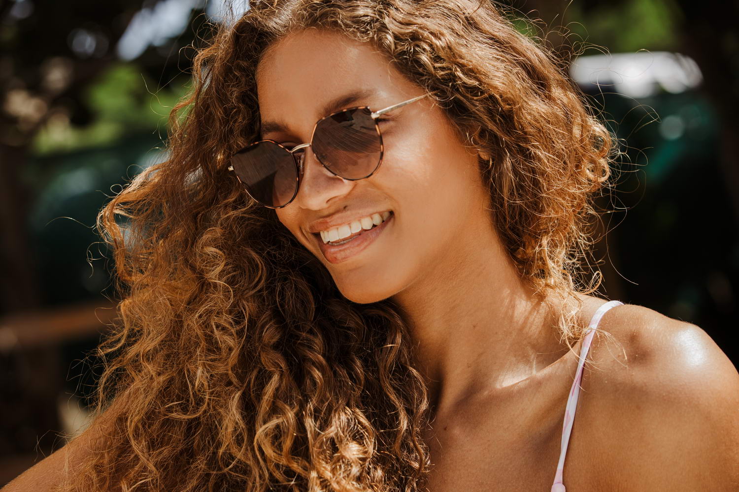 Woman wearing leopard print cat eye sunglasses outdoors with tinted lenses and modern fashion styling