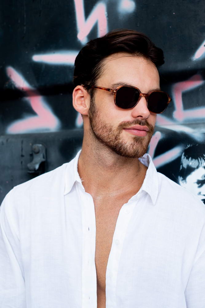 Man wearing leopard print square sunglasses with geometric frame for modern streetwear and casual luxury fashion