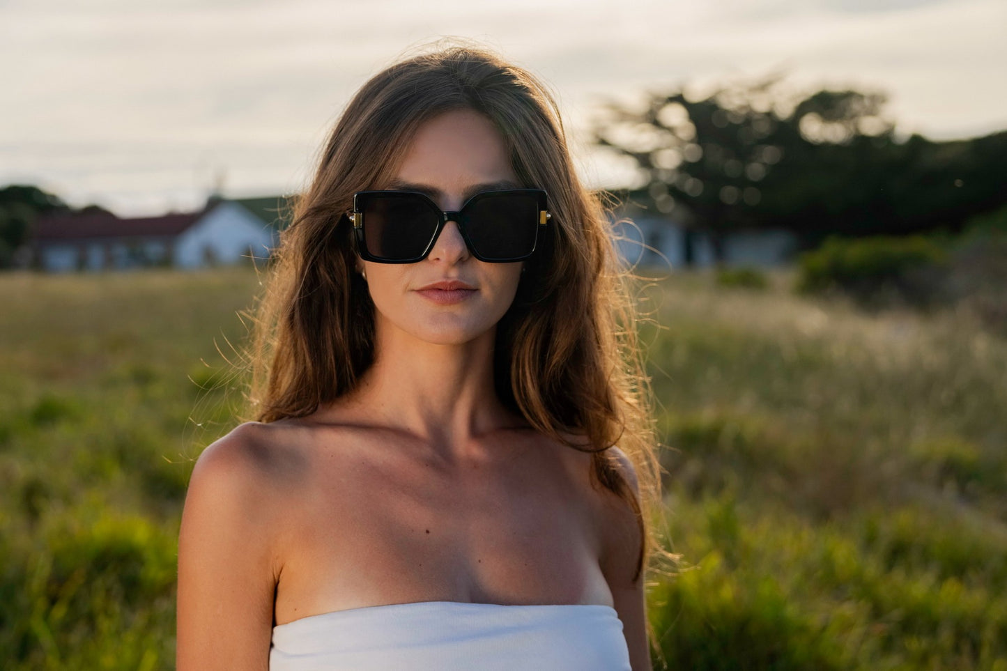 Woman wearing oversized Madrid sunglasses in brown tones, stylish summer look for travel outfits, sunny days and relaxed city fashion