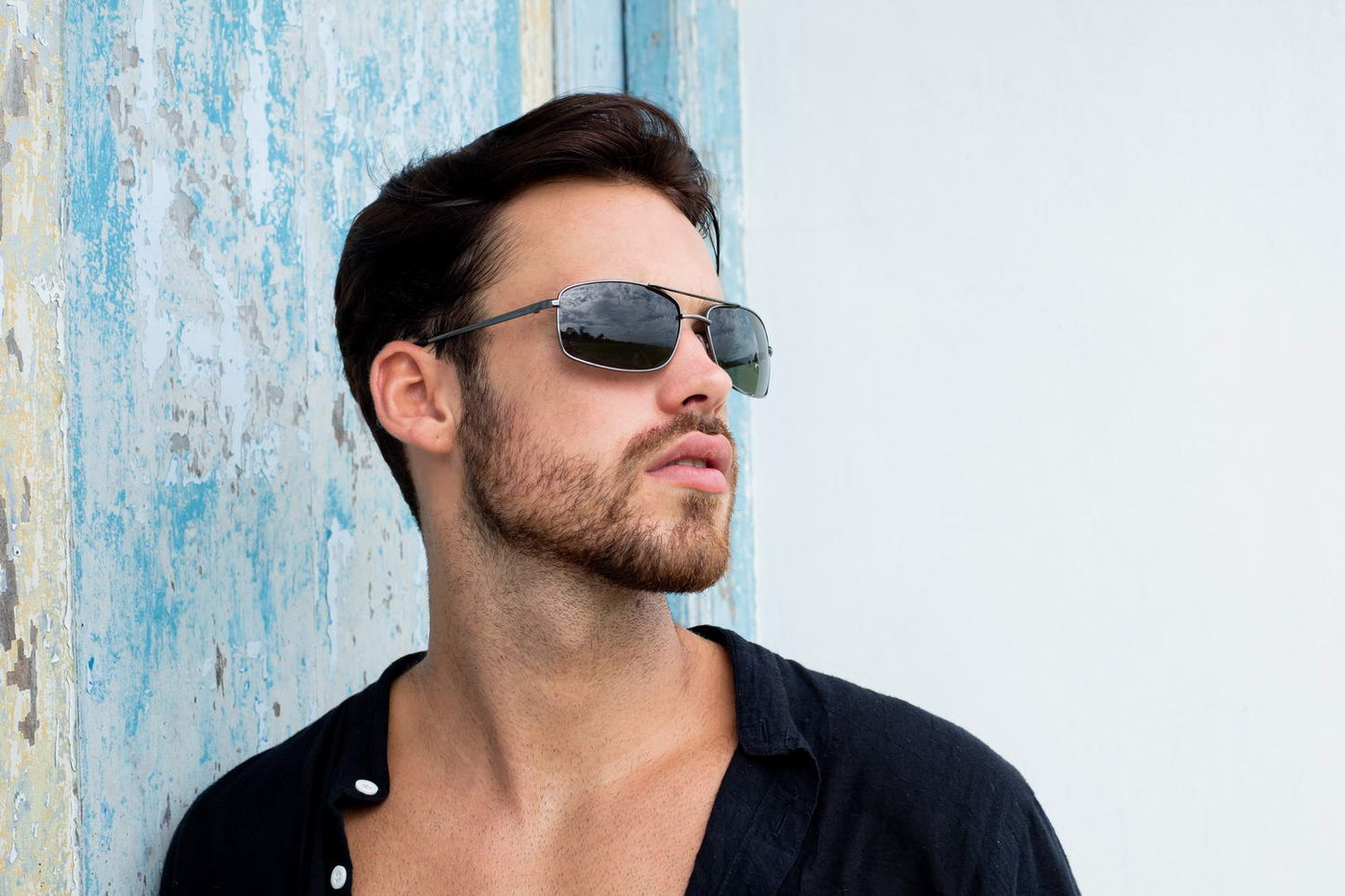 Man wearing metal rectangle sunglasses by Sunglass Station, vintage-style unisex eyewear suitable for outdoor use and everyday wear