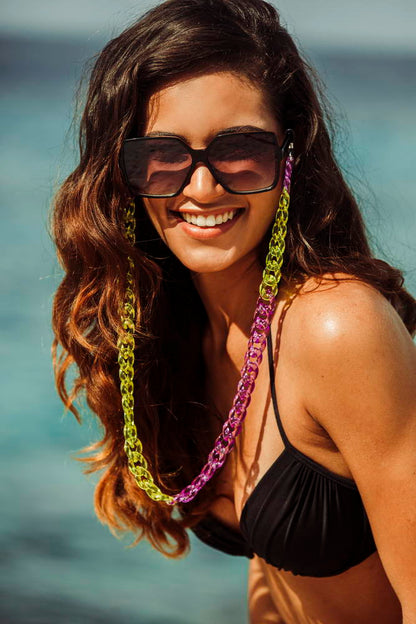 Woman wearing oversized sunglasses on a sunny beach, styled for holiday outfits with lightweight frame and comfortable fit