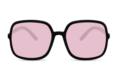 Oversized sunglasses with pink lenses and round black frame, stylish women sunglasses for holidays, summer fashion and casual looks