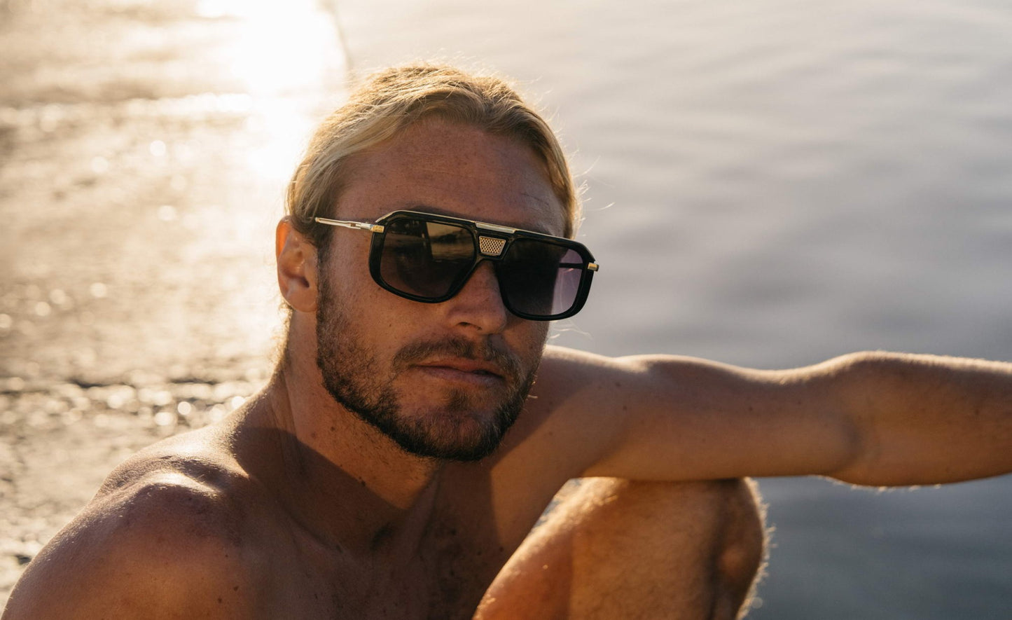 Rectangular aviator sunglasses worn in a travel setting, ideal for outdoor style and everyday fashion