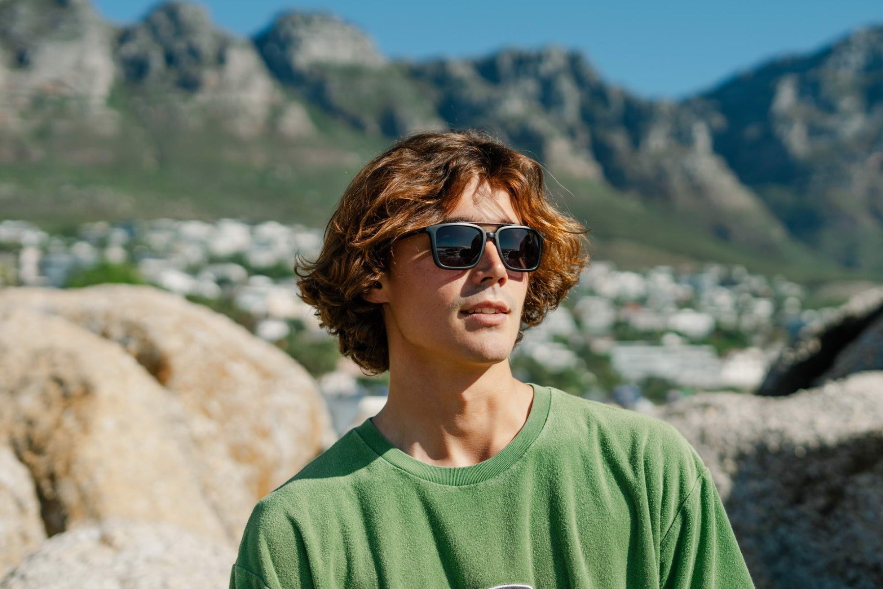 Retro aviator sunglasses styled in a casual outdoor setting, perfect for relaxed everyday fashion and travel looks