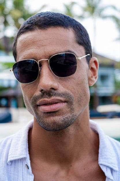 Man wearing black square sunglasses with minimalist metal frame for smart casual and streetwear fashion
