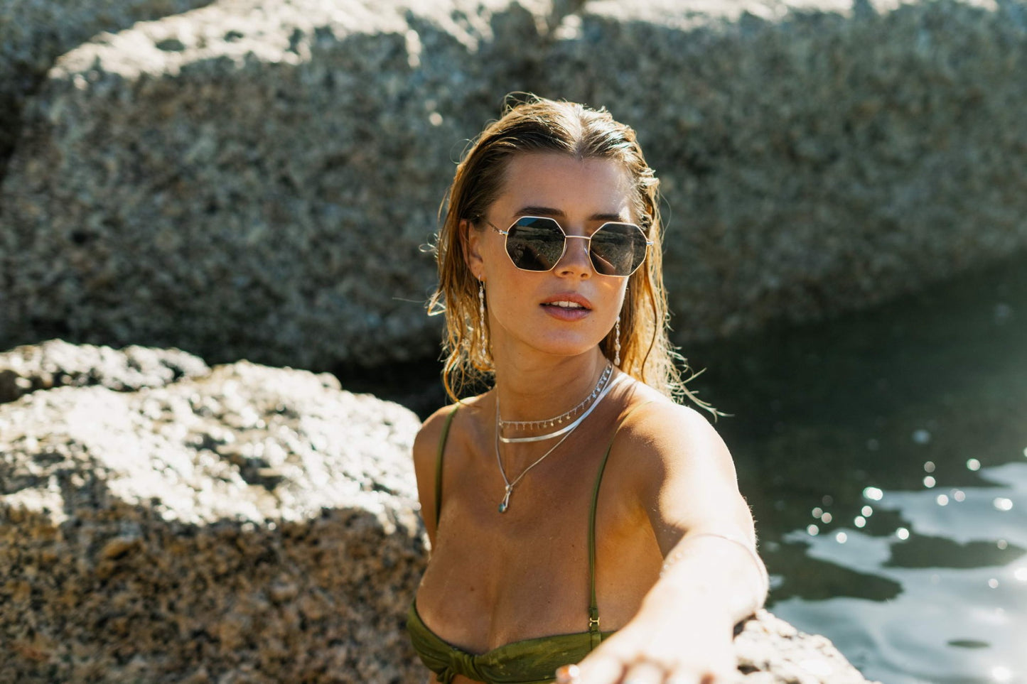 woman wearing black geometric frame round sunglass and enjoying at monte carlo beach