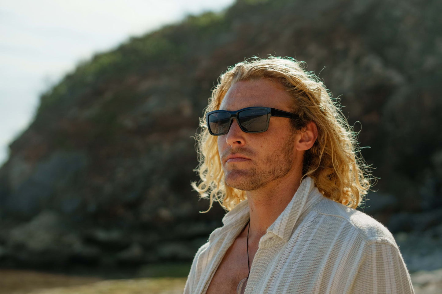 Black rectangle sunglasses worn by a man, featuring a bold frame and modern everyday look by Sunglass Station