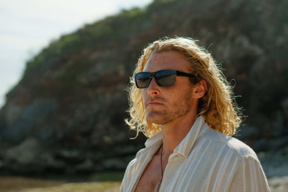 Black rectangle sunglasses worn by a man, featuring a bold frame and modern everyday look by Sunglass Station